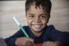 Un écolier joyeux avec un stylo à la main